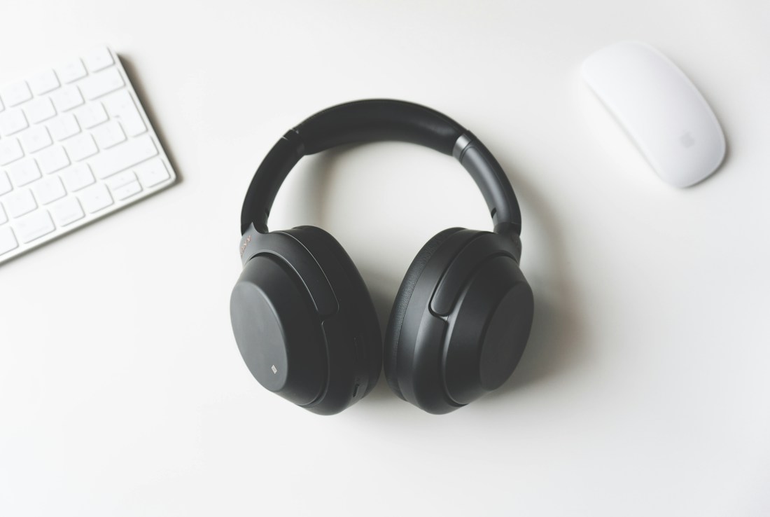Headphones on a warm neutral background